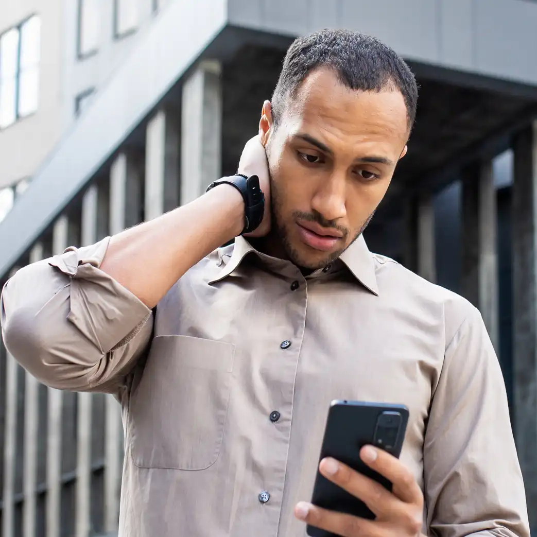 Concerned man looking at his cellphone