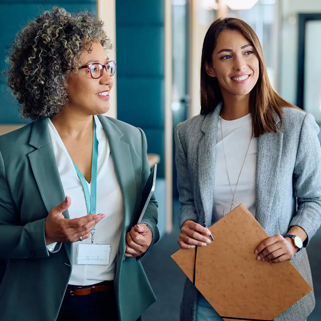Two businesswomen talking and smiling